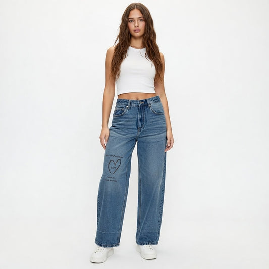 Woman wearing blue jeans with a heart design on a white background