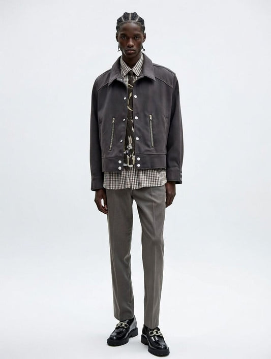 Man wearing a dark gray jacket and pants on a white background