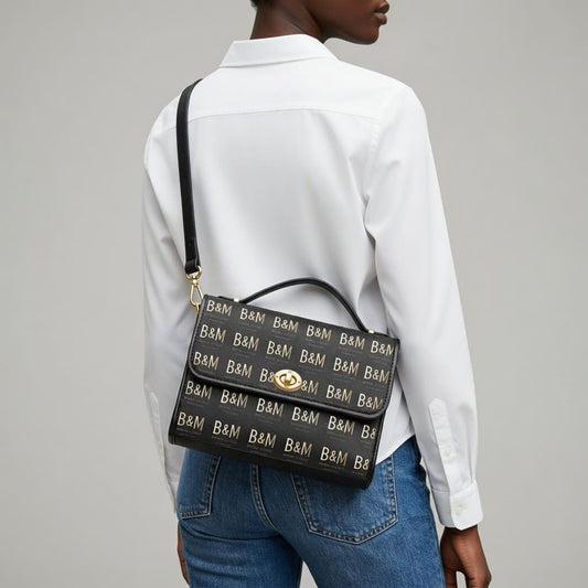 Person wearing a black handbag with 'B&M' pattern on a plain background